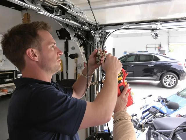 Stallings Garage Door Repair safety certified technician performing cable replacement in Stallings
